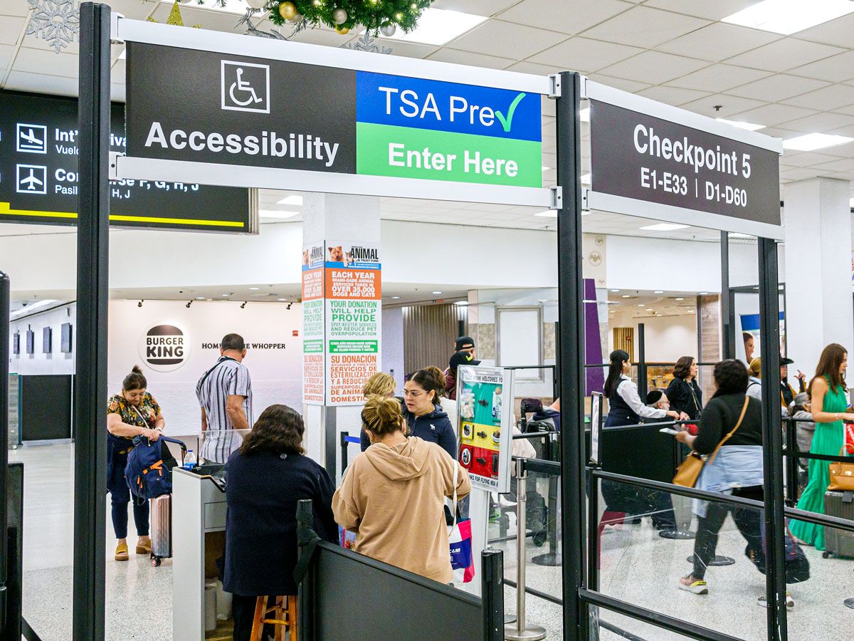 Travelers passing through TSA PreCheck checkpoint at airport
