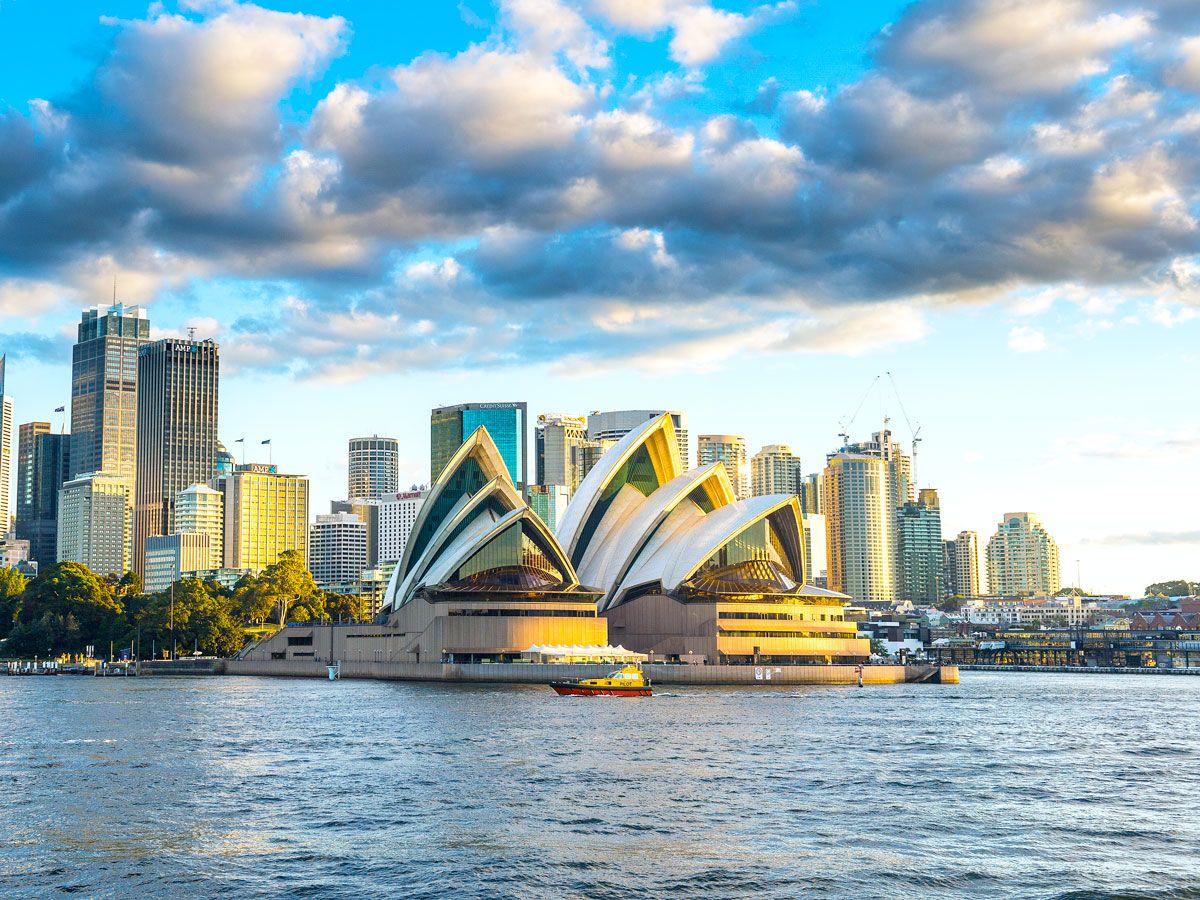 Sydney Opera House alongside Sydney Harbour and skyline
