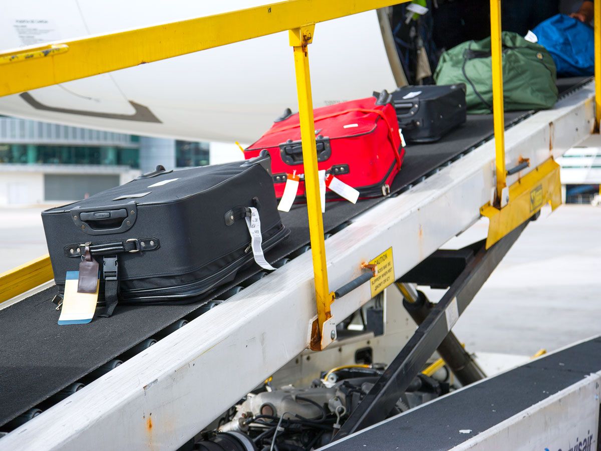 Conveyor belt with luggage being loaded onto aircraft