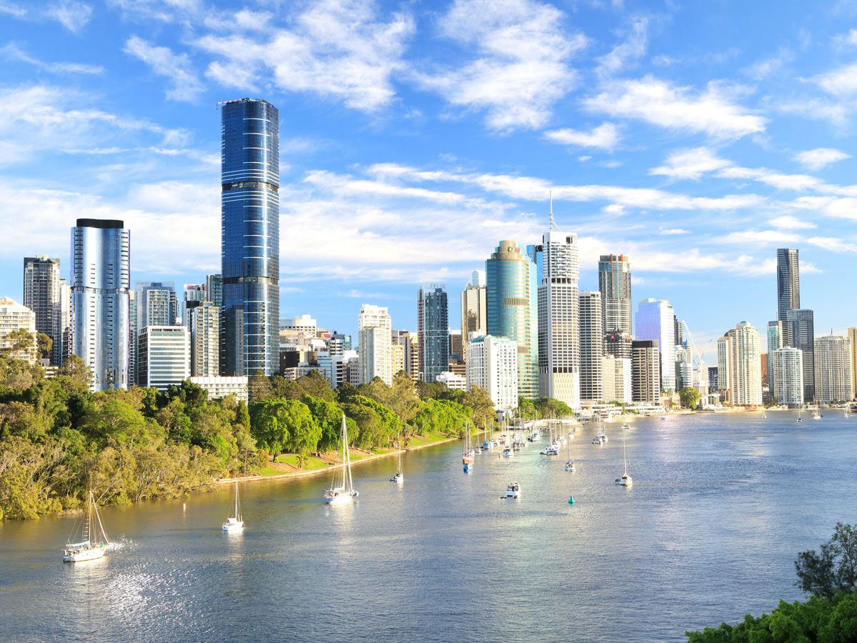 Sailboats alongside skyline of Brisbane, Australia