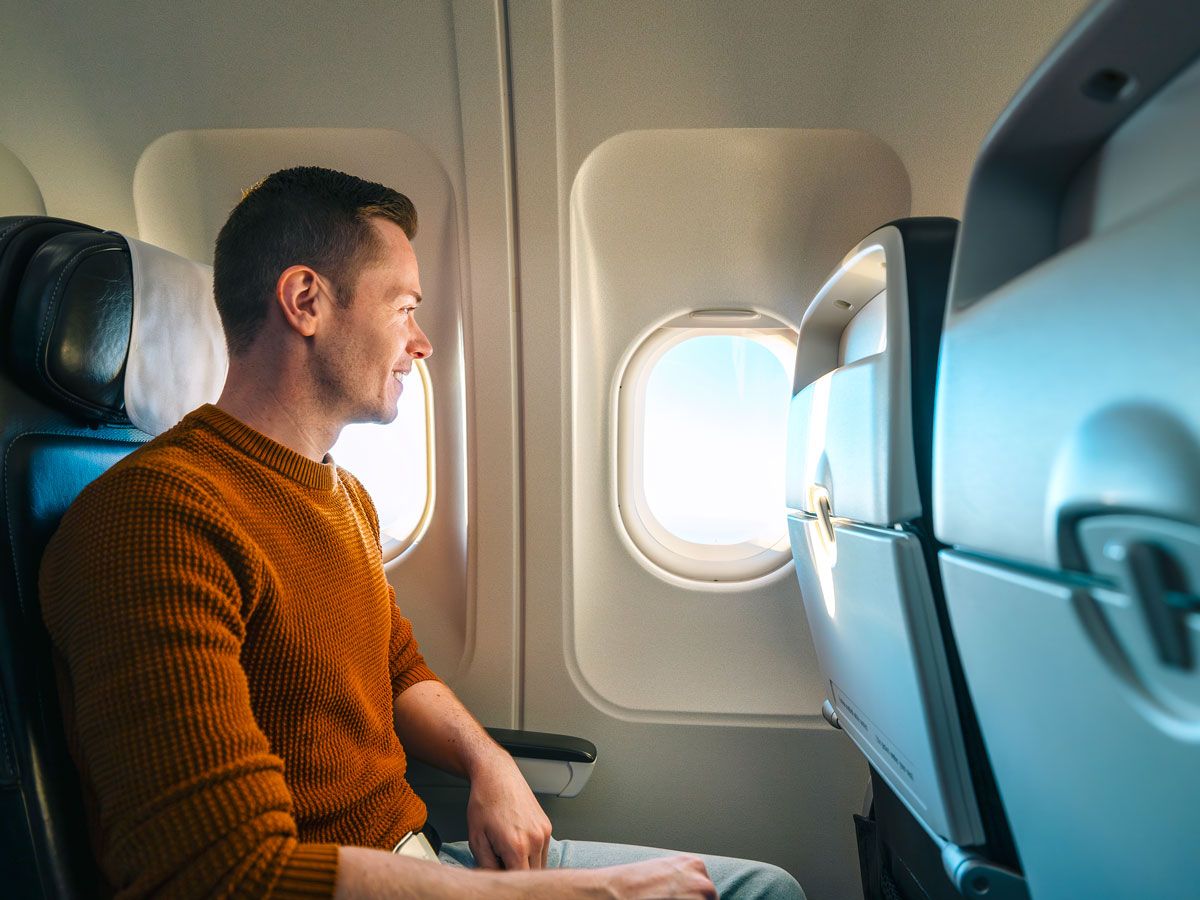 Passenger looking out airplane window