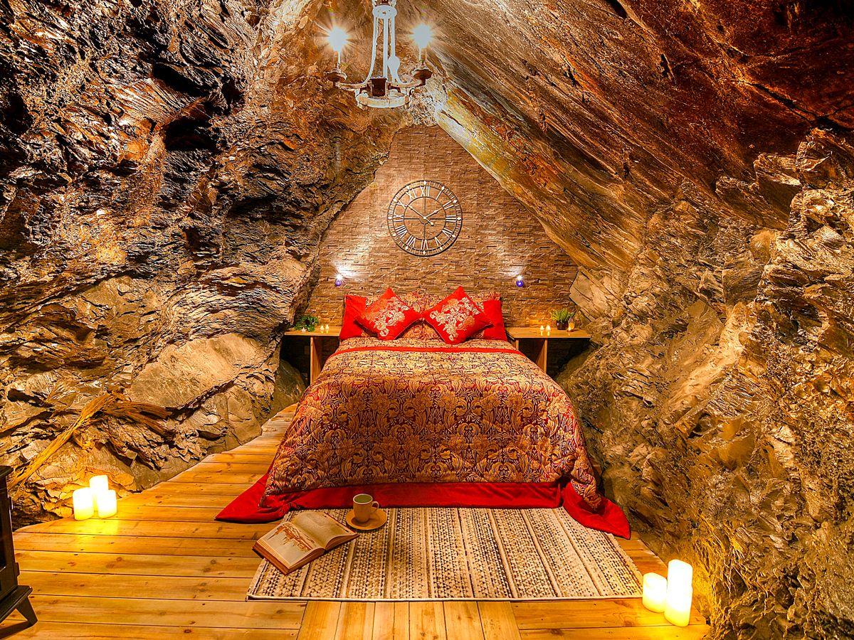 Bed inside cave room at Deep Sleep in Wales