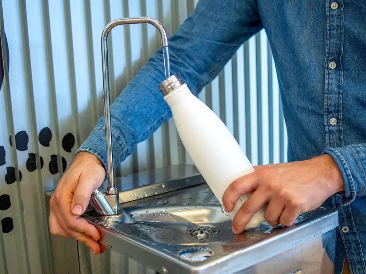 Person refilling water bottle