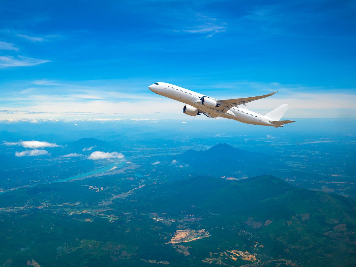 Airplane ascending over mountains