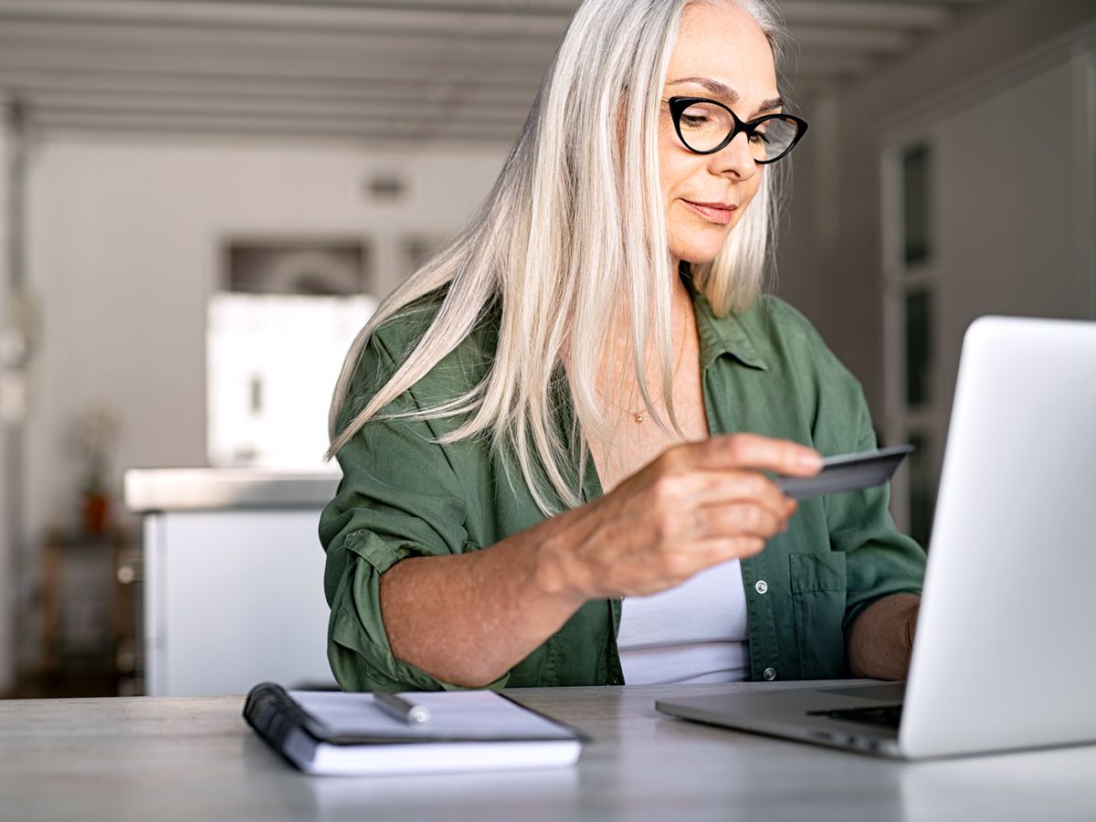 Woman using credit card to make online purchase