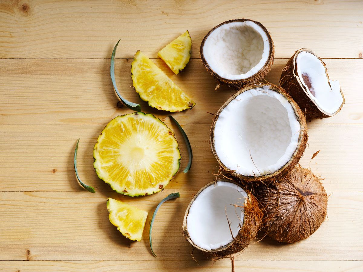 Fresh coconut and pineapple on cutting board