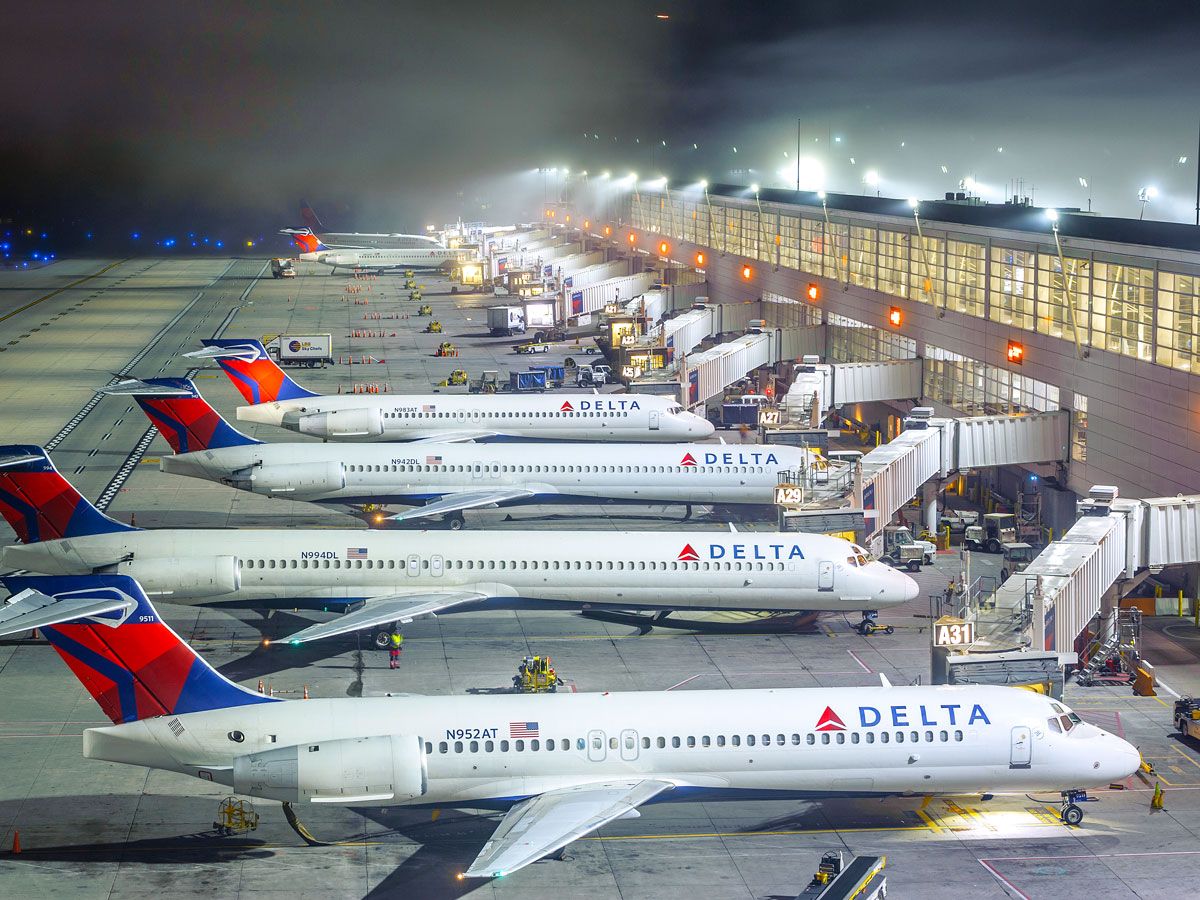 Delta Air Lines aircraft parked at terminal at night