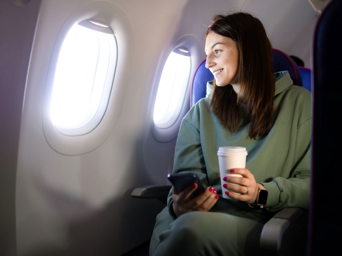 Woman looking out airplane window
