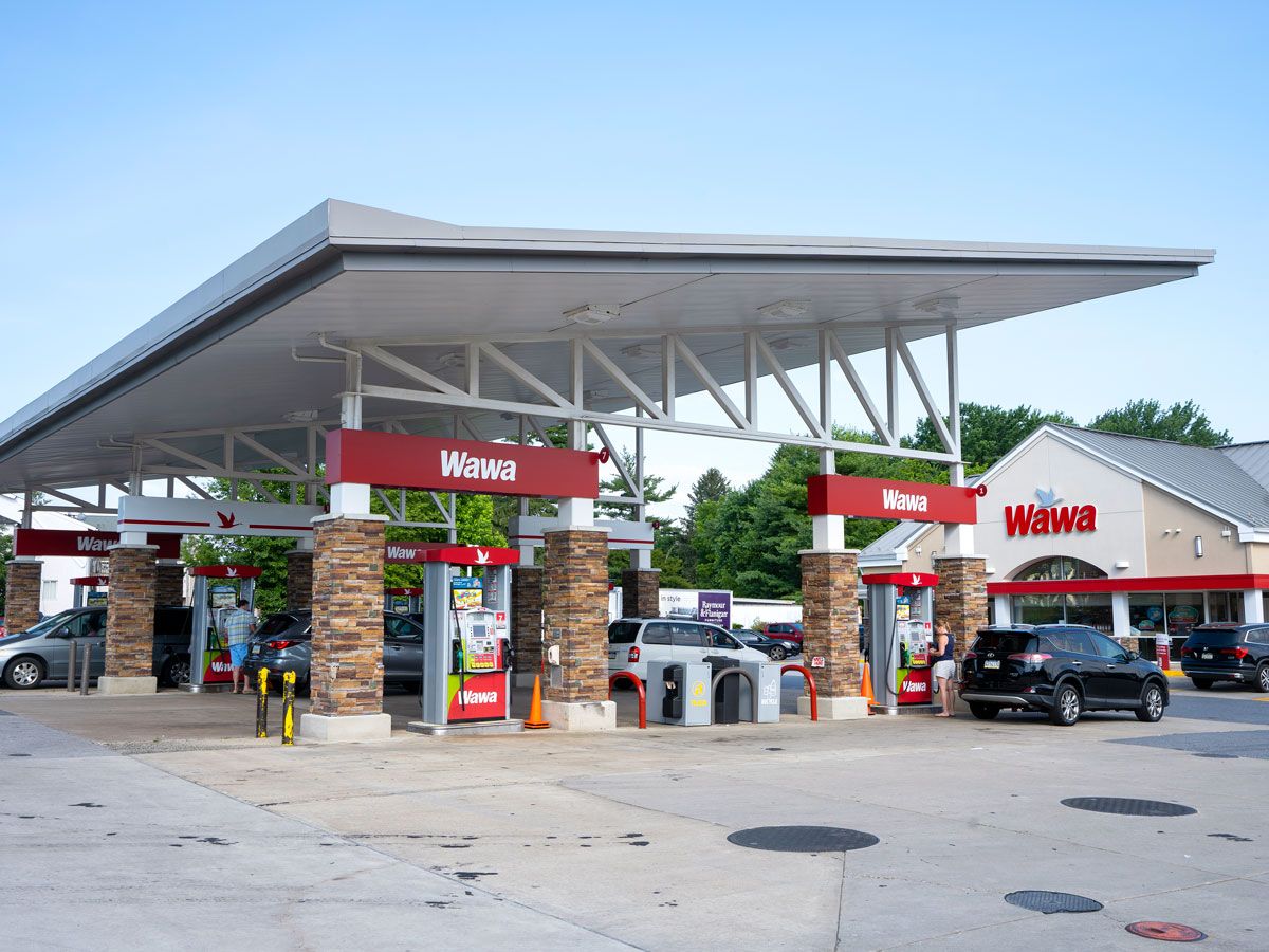 Gas station pumps and exterior of Wawa convenience store