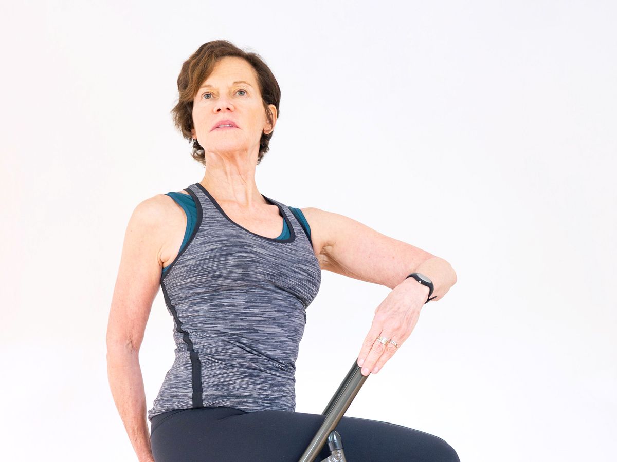Woman stretching torso in chair