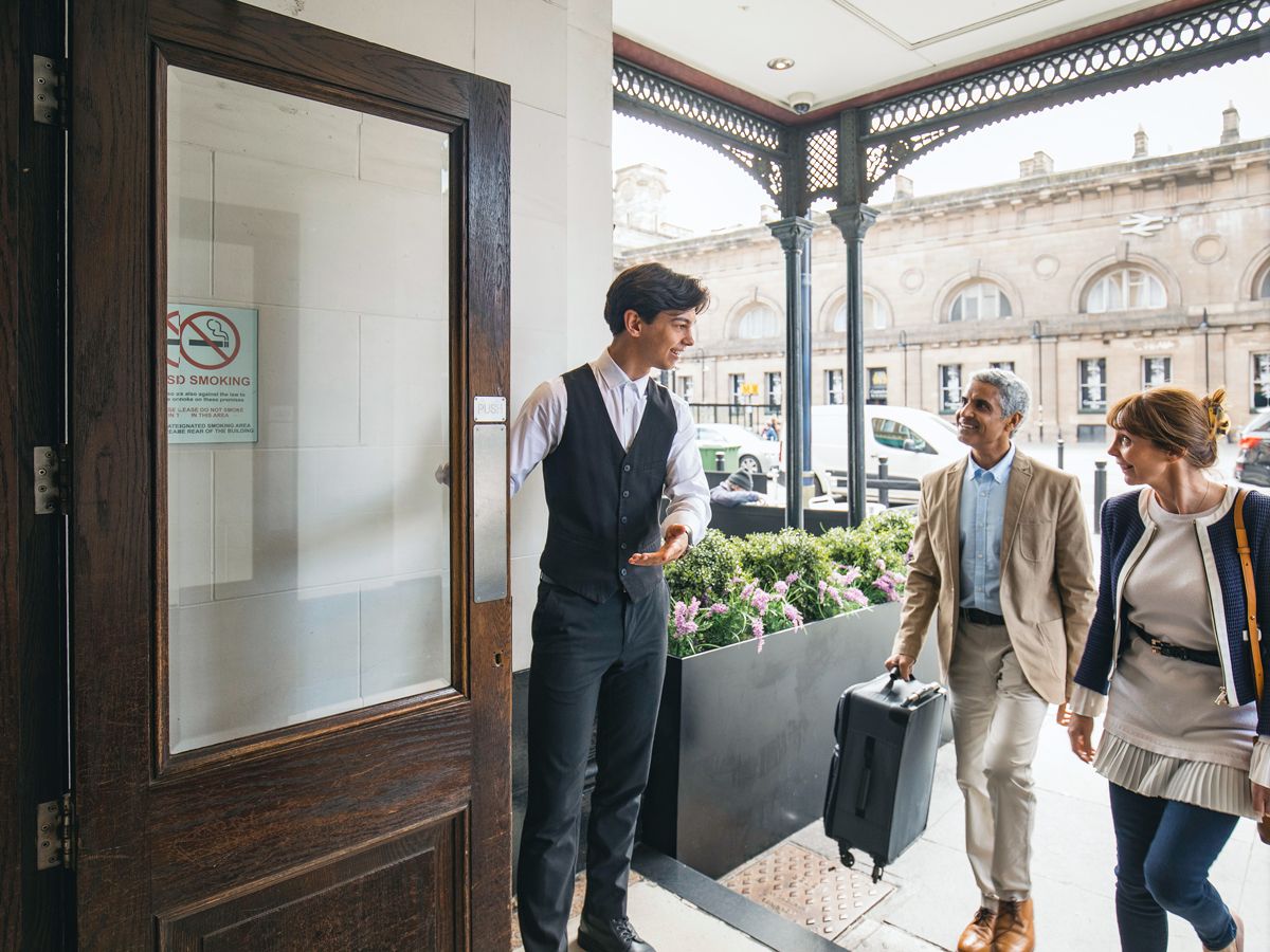 Doorperson welcoming hotel guests