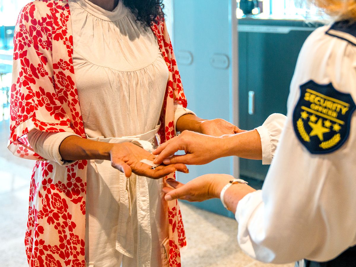 Traveler receiving hand swab from TSA officer