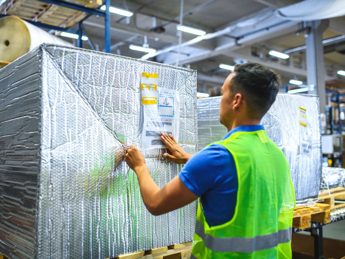 Airport employee packaging freight