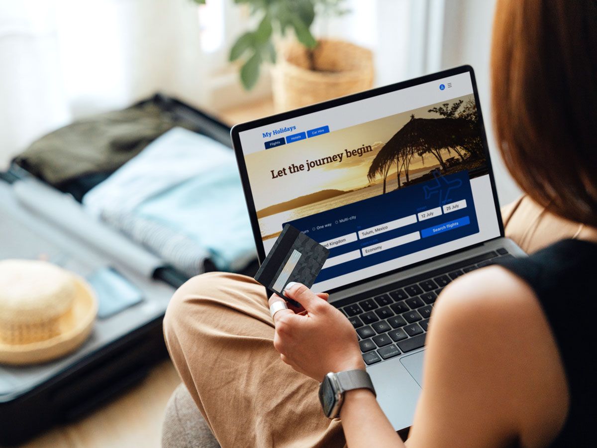 Person shopping for flights on laptop computer