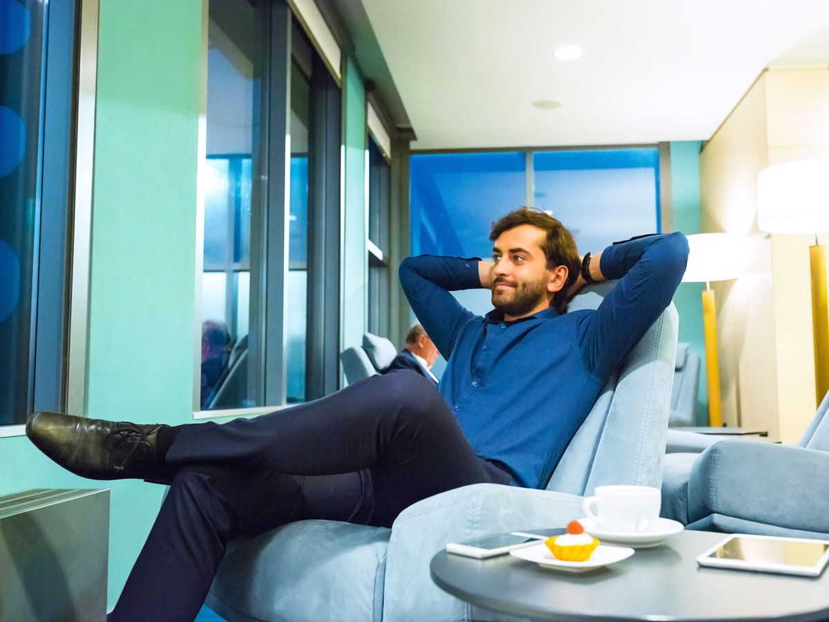 Passenger relaxing in airport lounge