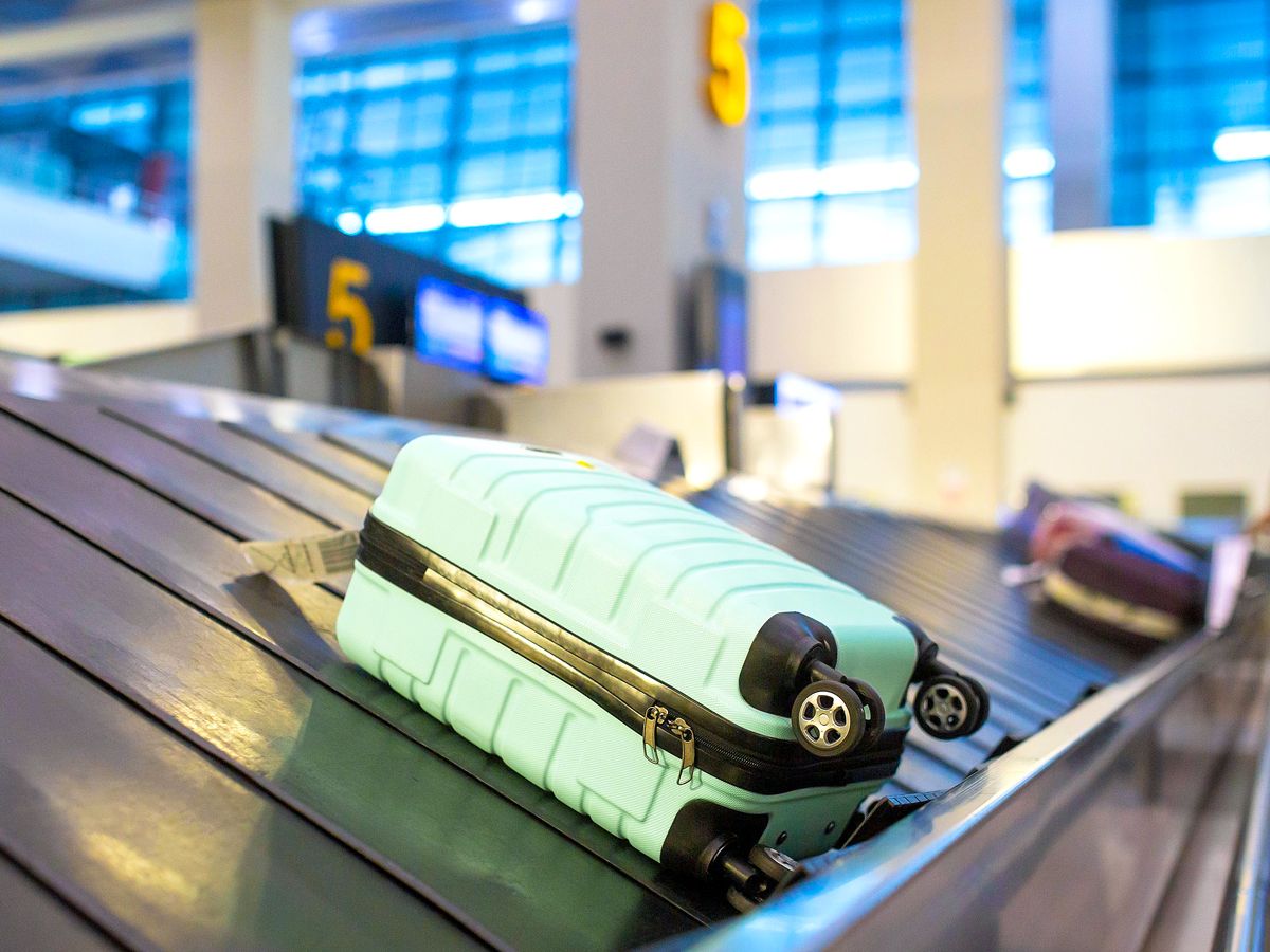 Luggage on airport baggage claim carousel 