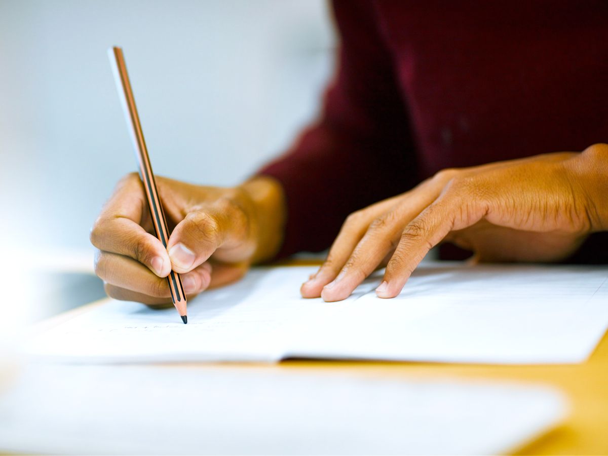 Person writing in notebook