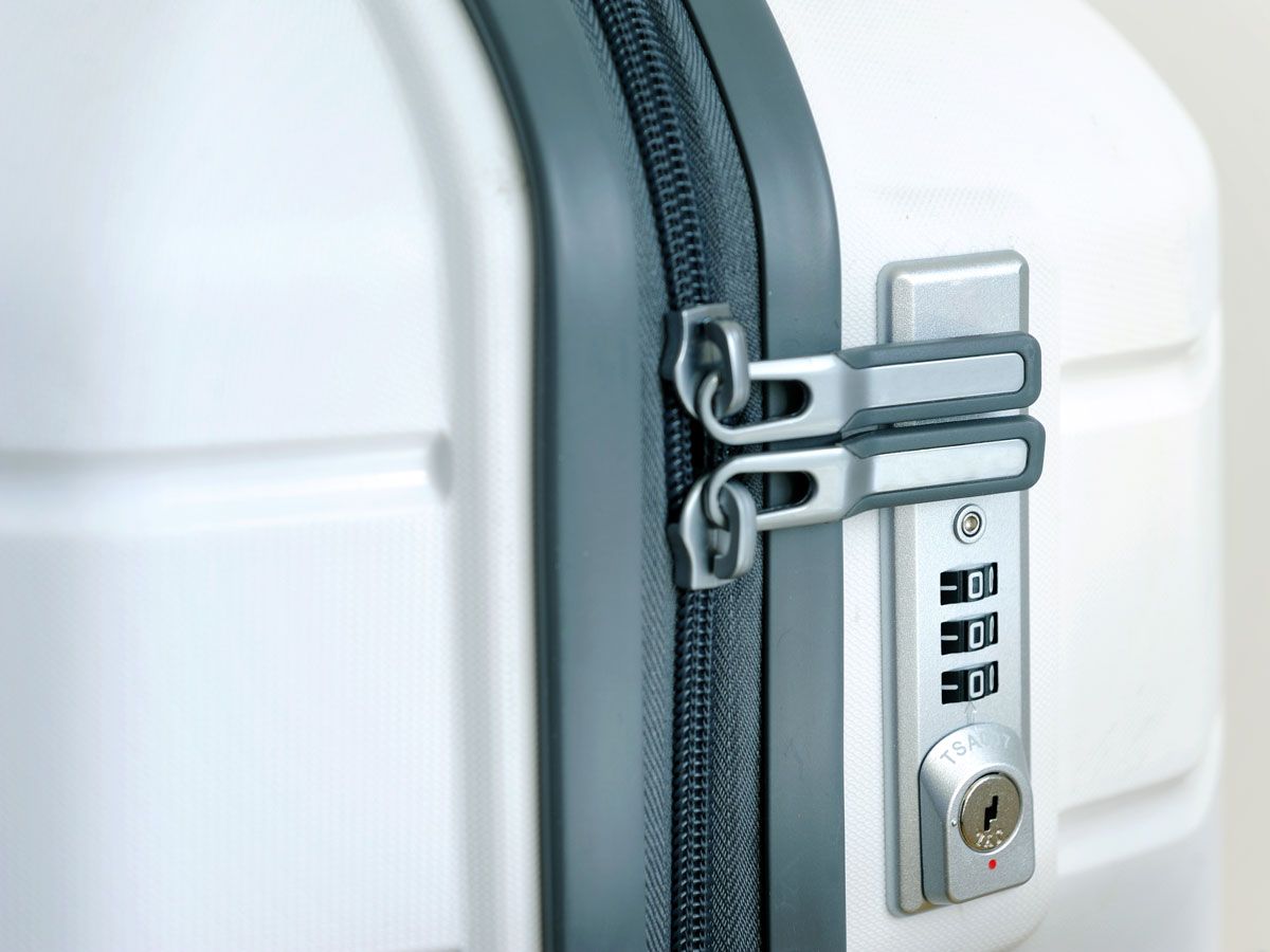 Close-up view of zipper and luggage lock on suitcase