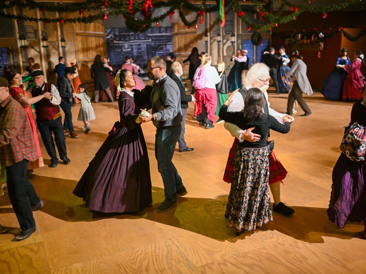 Dancers in costume at the Great Dickens Christmas Fair in Daly City, California
