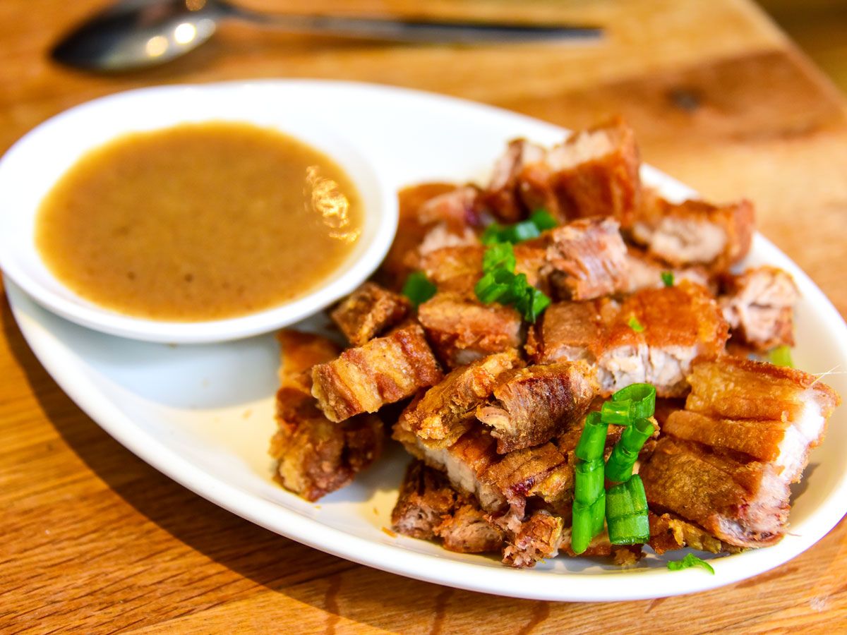 Plate of lechon with dipping sauce
