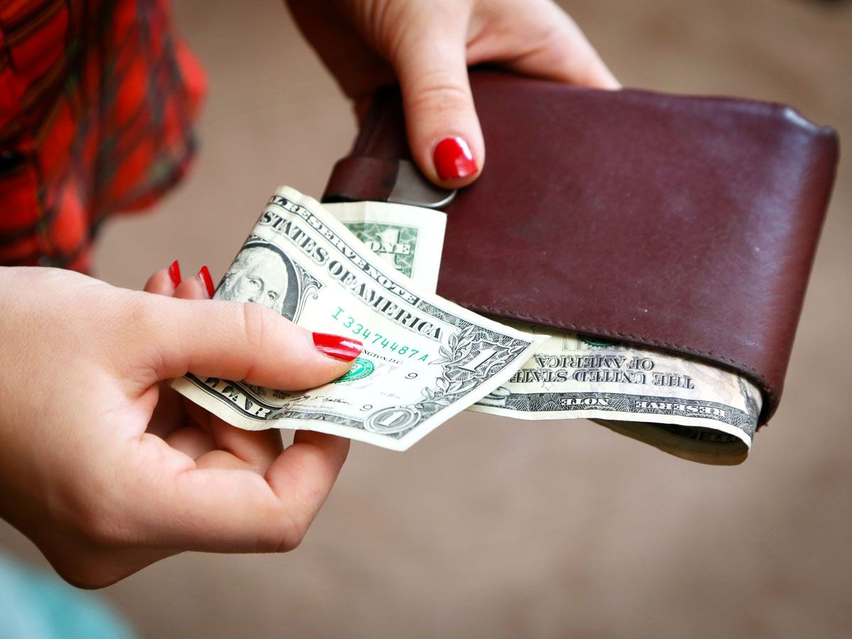 Person taking $1 bill out of wallet