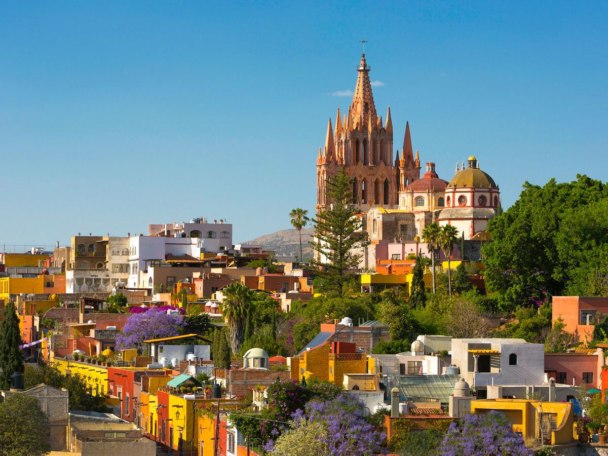 Church towering above colorful buildings in San Miguel de Allende, Mexico