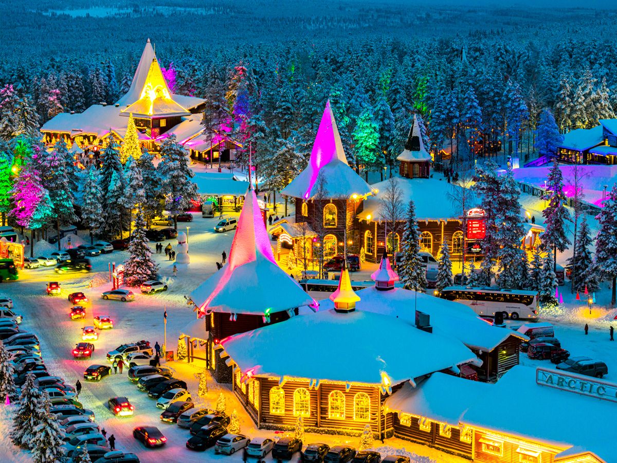 Snowy Santa Claus Village in Finland lit up with Christmas lights