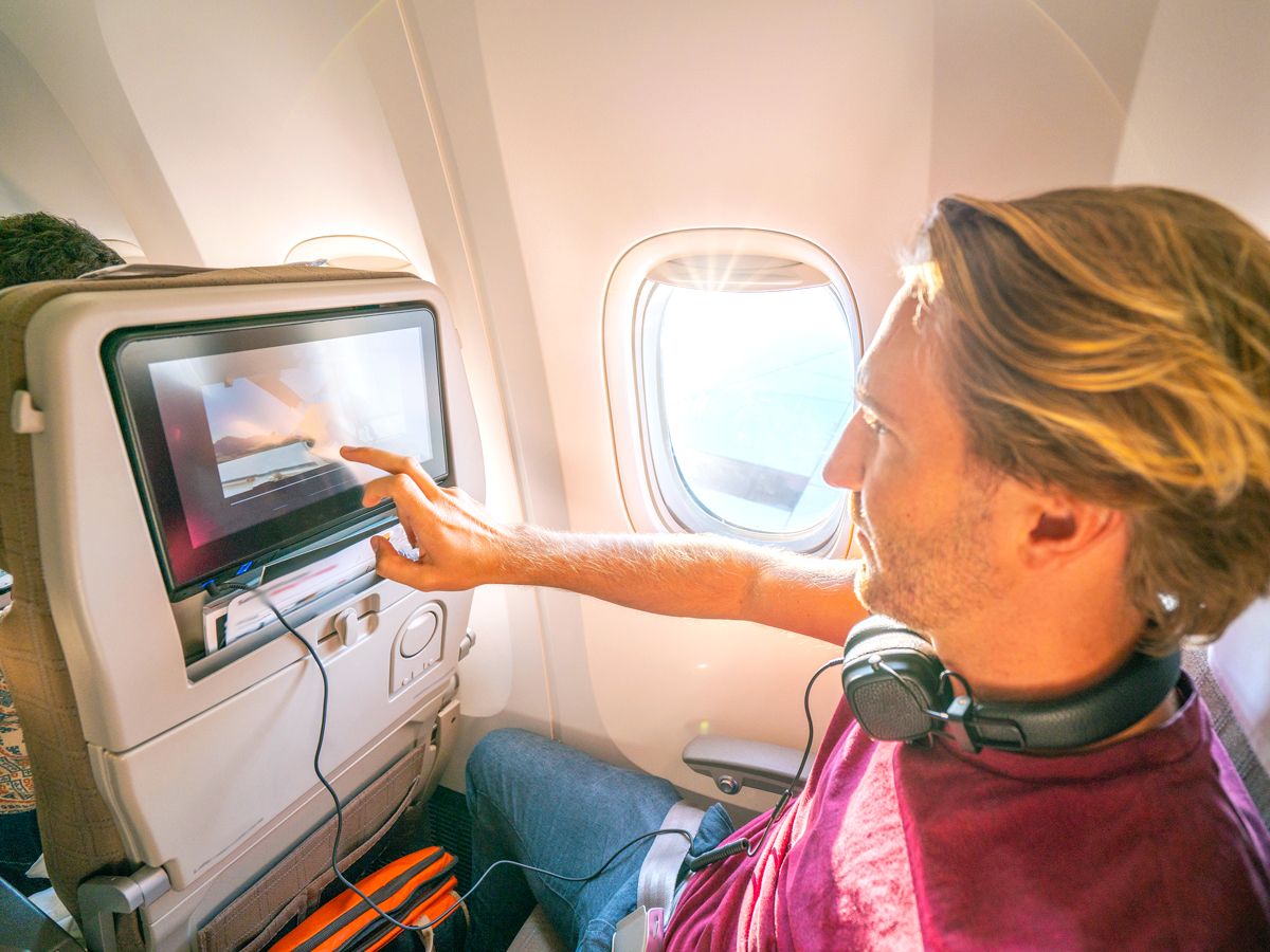 Passenger navigating seatback entertainment screen