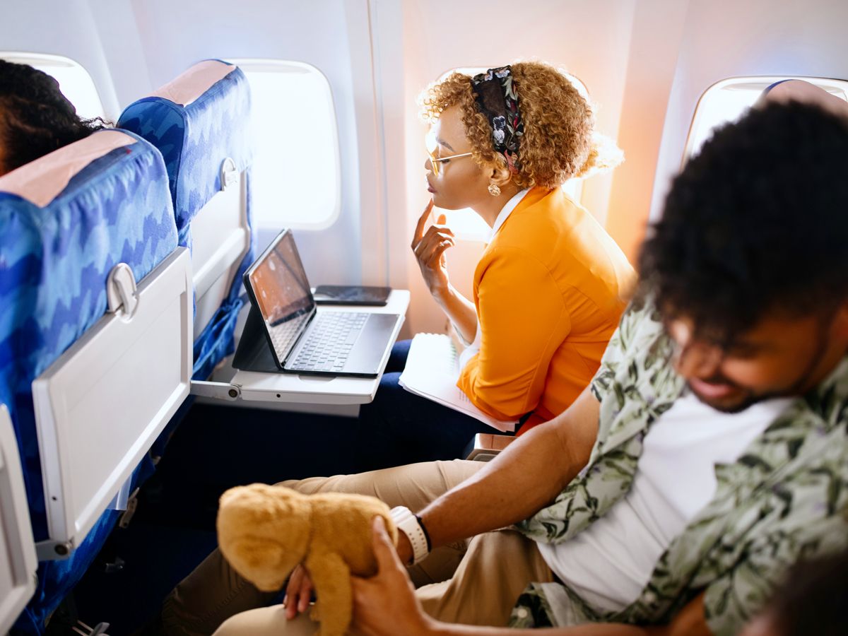 Passenger watching tablet on tray table