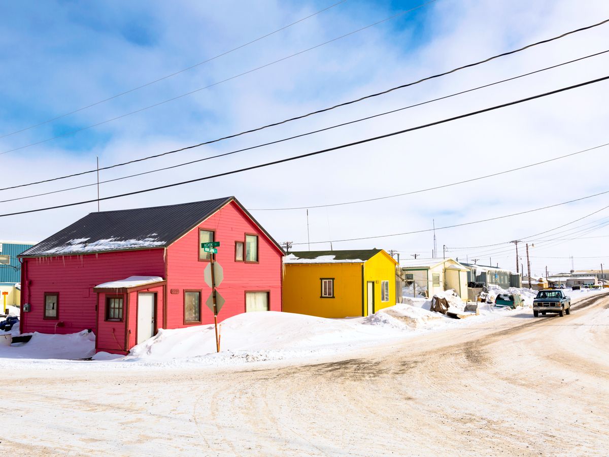 Snowy street with colorful homes in Utqiaġvik, Alaska
