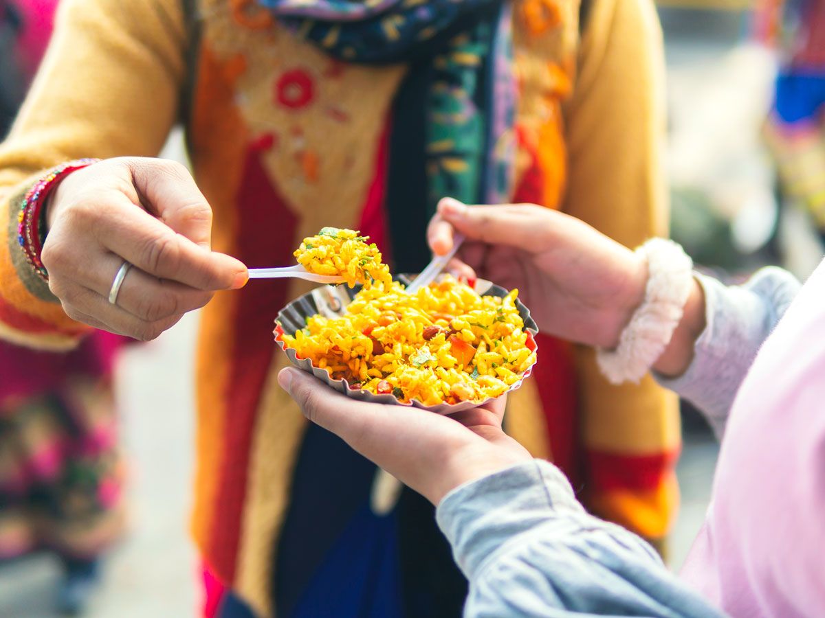 Two people sharing bowl of food