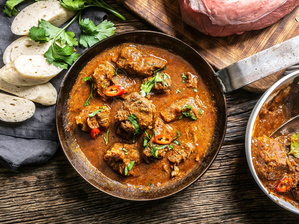 Pot of goulash on cutting board