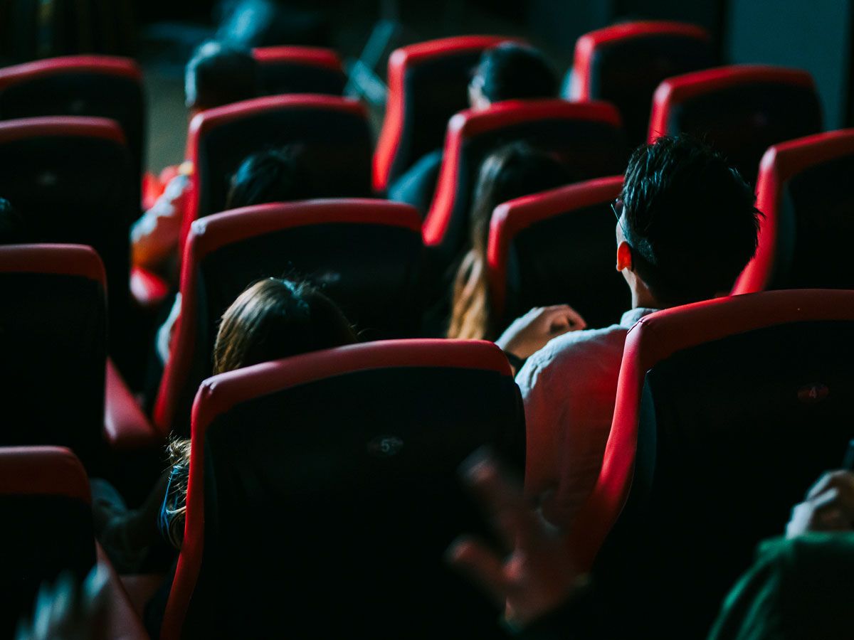 People watching film in movie theater