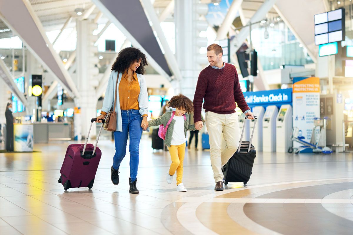 Family walking through airport terminal