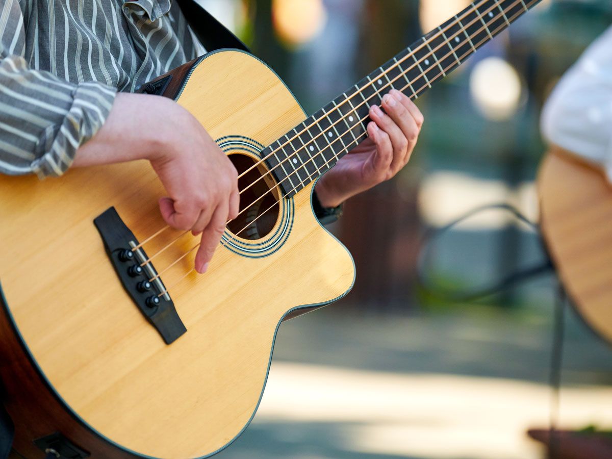 Musician playing acoustic guitar