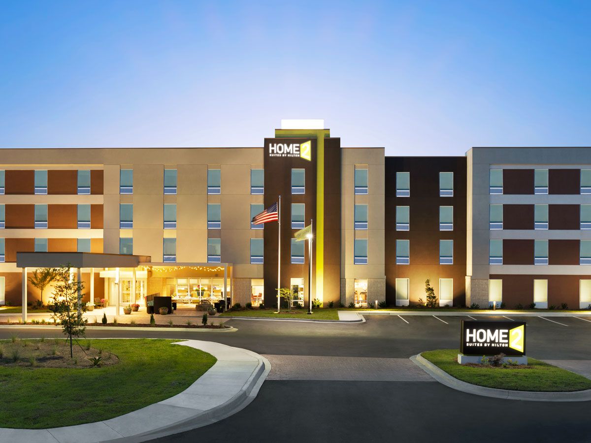 Exterior of a Home 2 Suites by Hilton location illuminated at night