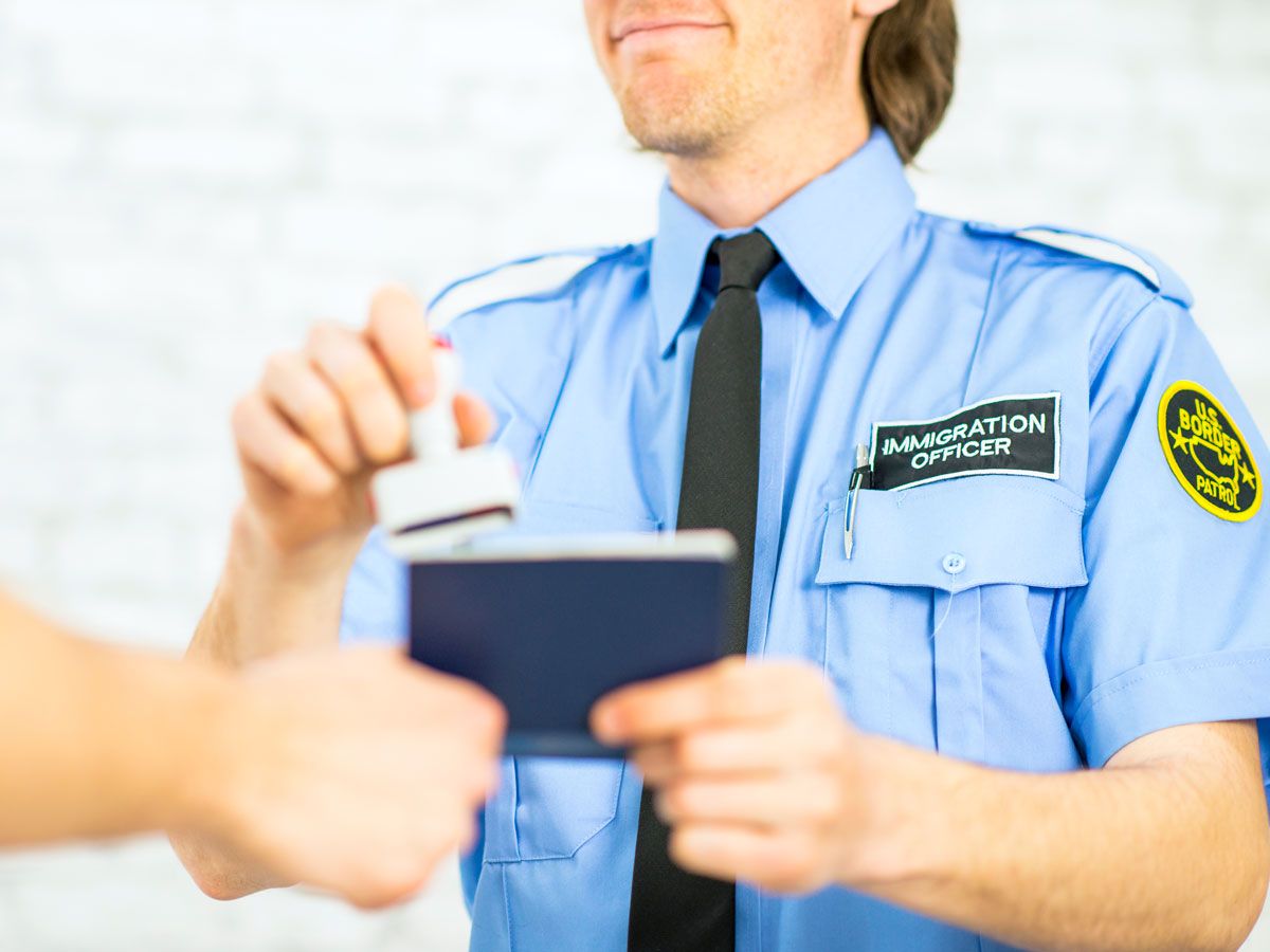 Immigration officer stamping a traveler's passport