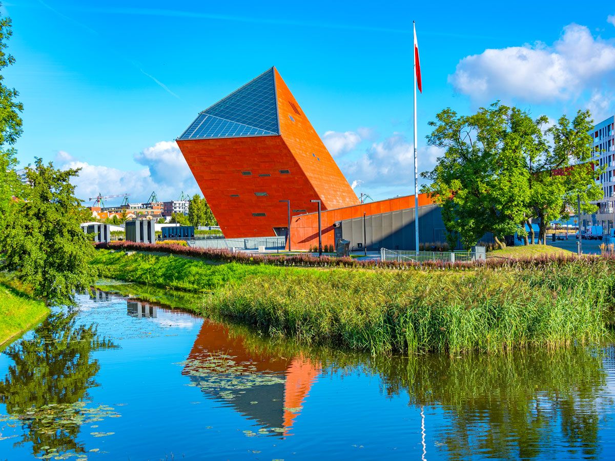 Exterior of the Museum of the Second World War, with reflection on surrounding water