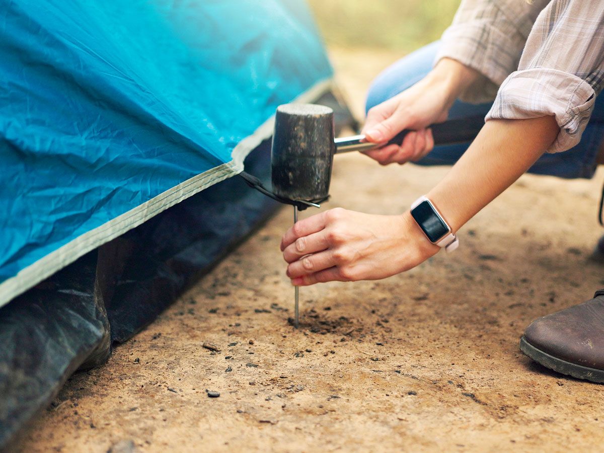 Person pitching a tent