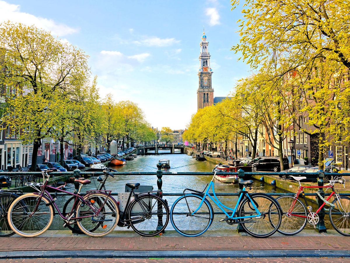 Bikes secured to bridge over canal in Amsterdam