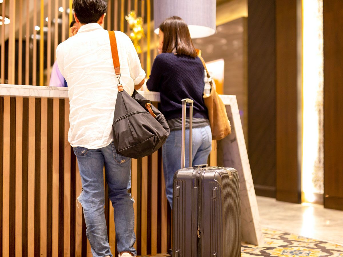 Guests at front desk of hotel