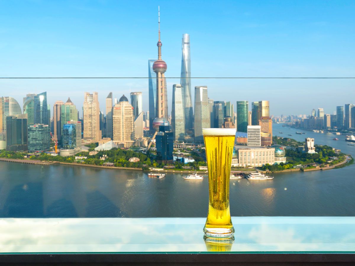 Pint of beer beside window overlooking Shanghai skyline