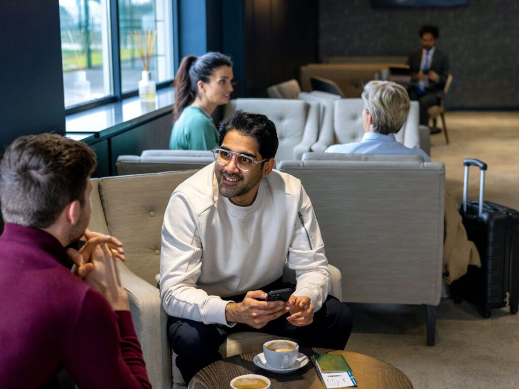 Guests conversing in airport lounge