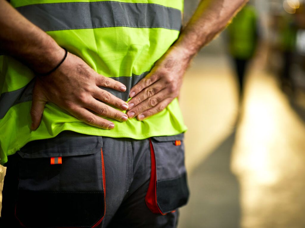 Security officer with hands on back, seen from behind