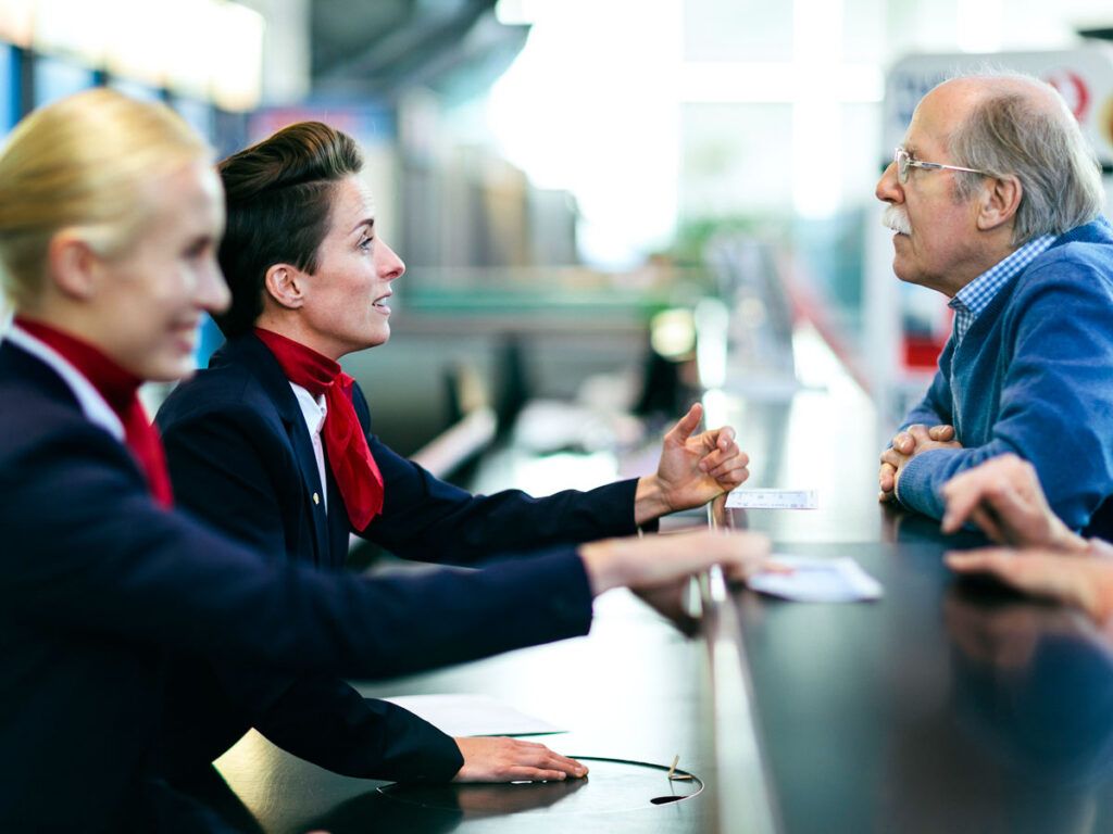 Gate agents speaking with passengers