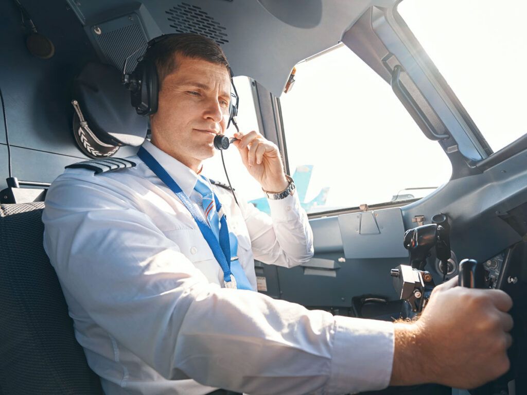 Pilot communicating on radio headset