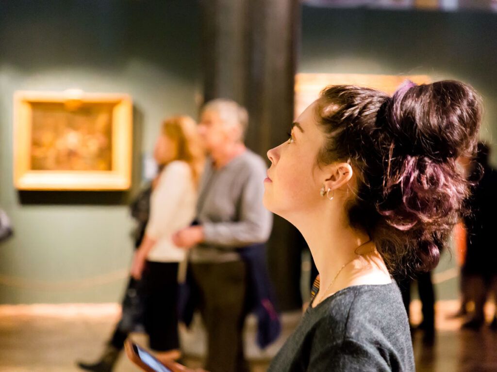Person viewing works of art in museum
