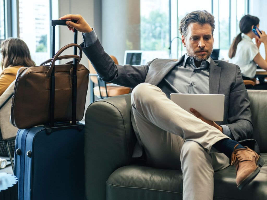 Lounge user sitting next to luggage
