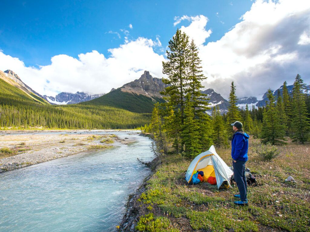 Person camping next to river in Banff National Park, Alberta