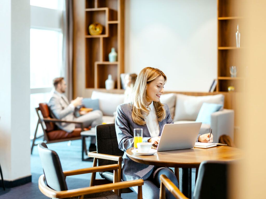 Travelers working in airport lounge